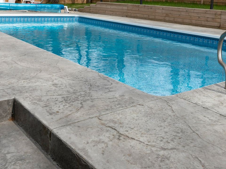 A pool technician cleaning a swimming pool